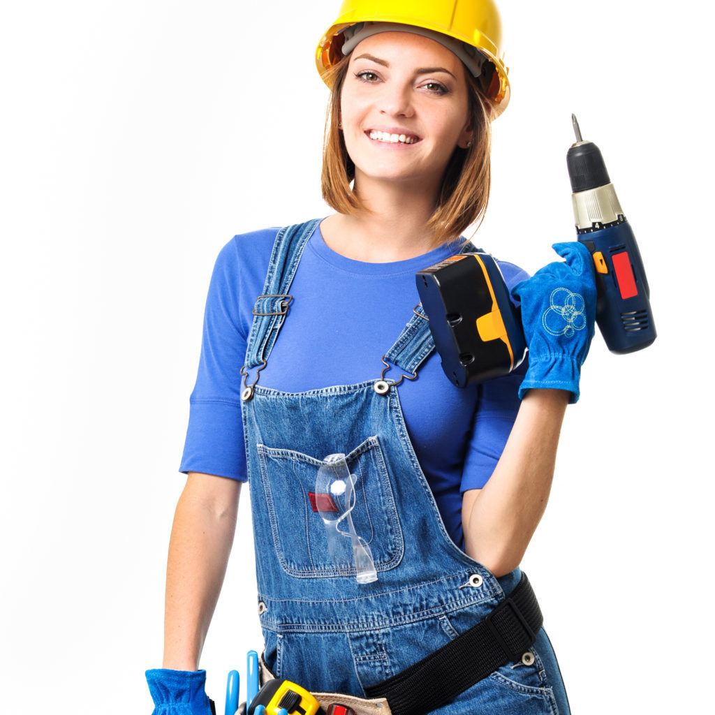 Woman in hard hat and work clothes with drill and tool belt