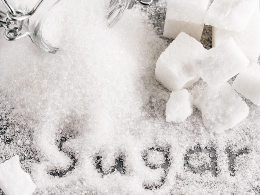 Close up view of word sugar of granulated sugar. sugar cubes