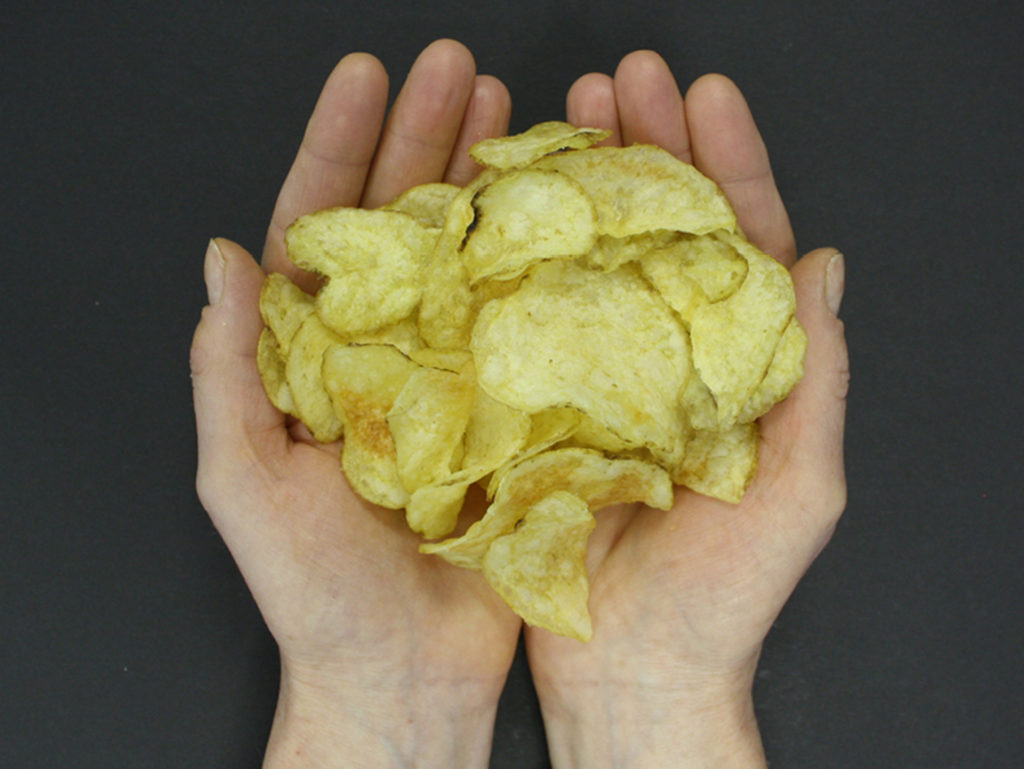 Hands holding crisps