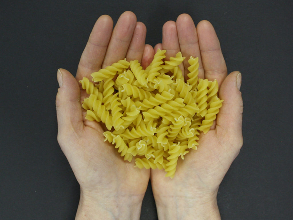 Hands holding pasta