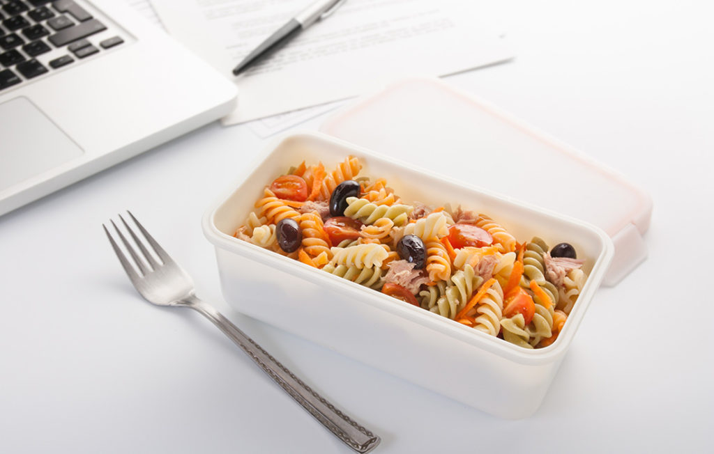 Eating a pasta salad with vegetables and tuna in the office Pic: Istockphoto