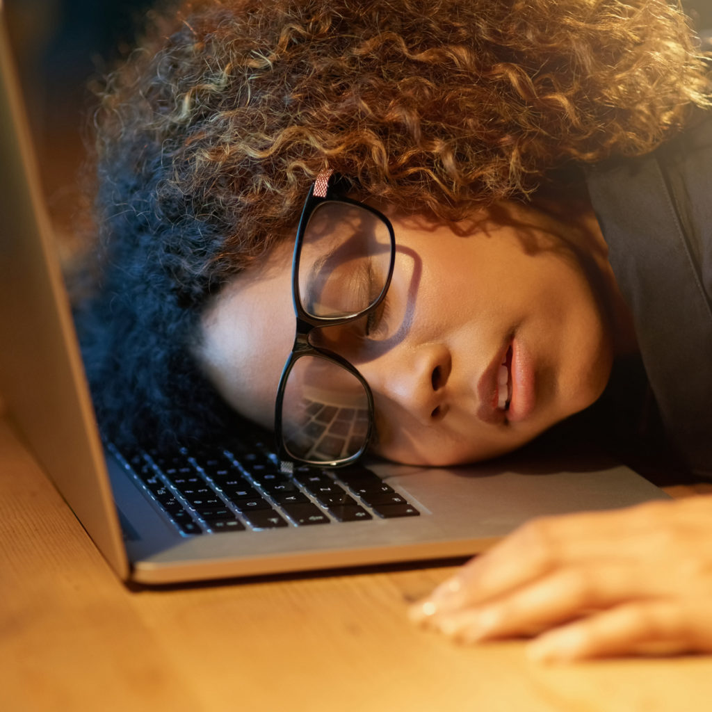 Cropped shot of a young businesswoman sleeping on her laptop while working late in an office
