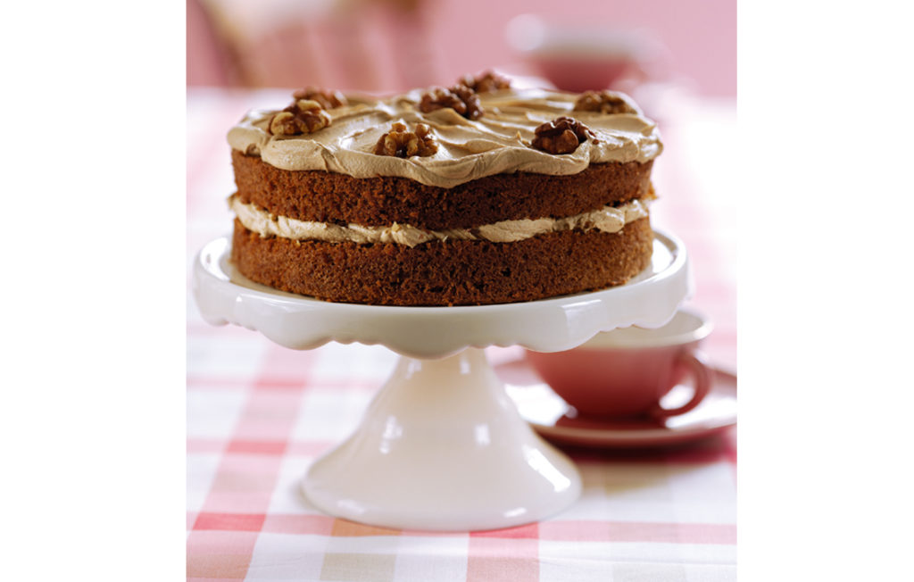 Coffee and walnut cake on a cake stand