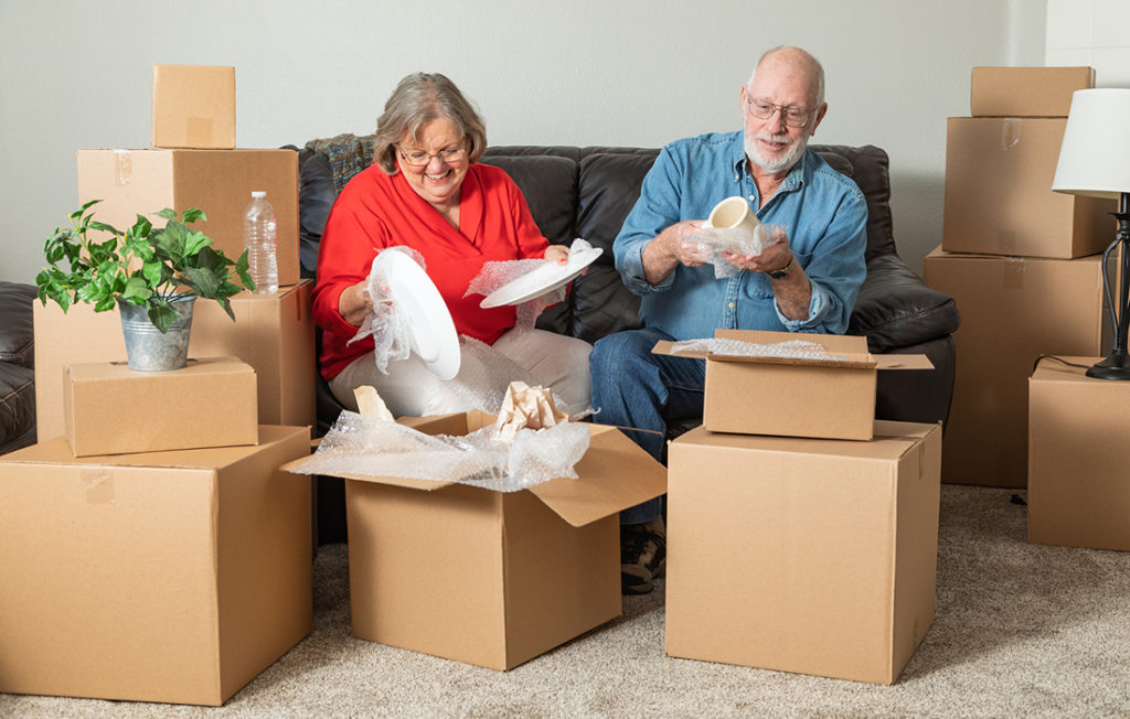 Senior Adult Couple Packing  Moving Boxes.