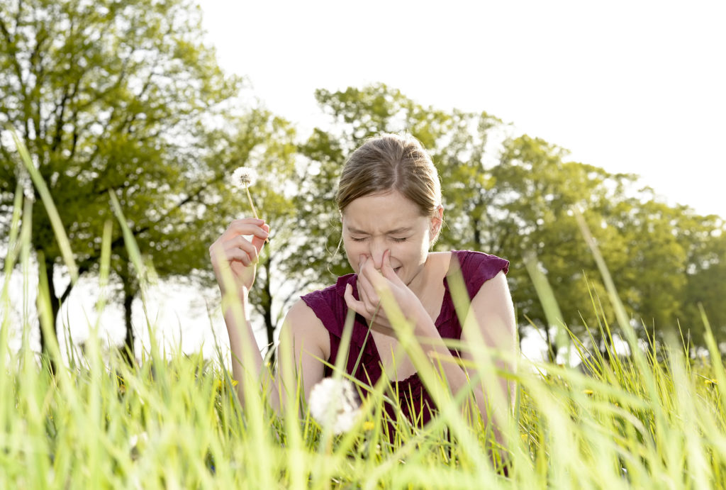 Woman with hay fever in field
