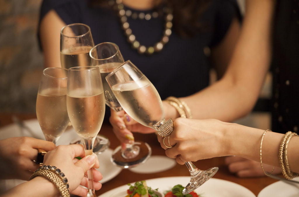 Close-up of the hands of the girls making a toast.