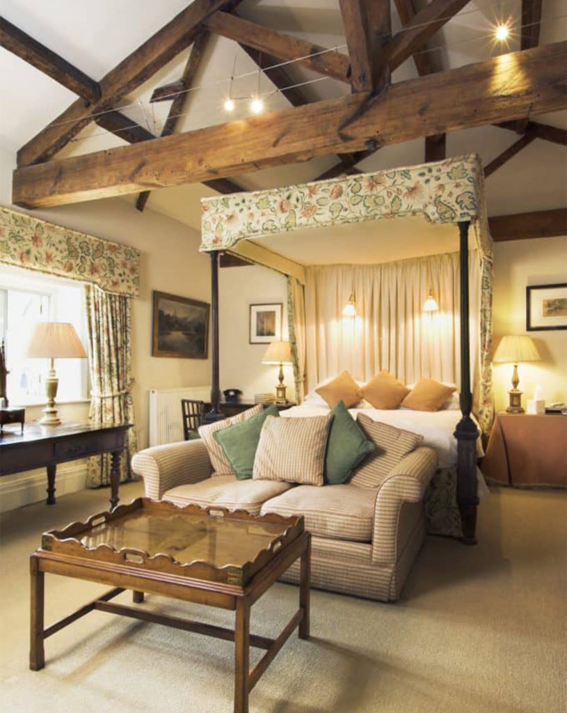 Exposed triangular roof beams and four poster bed