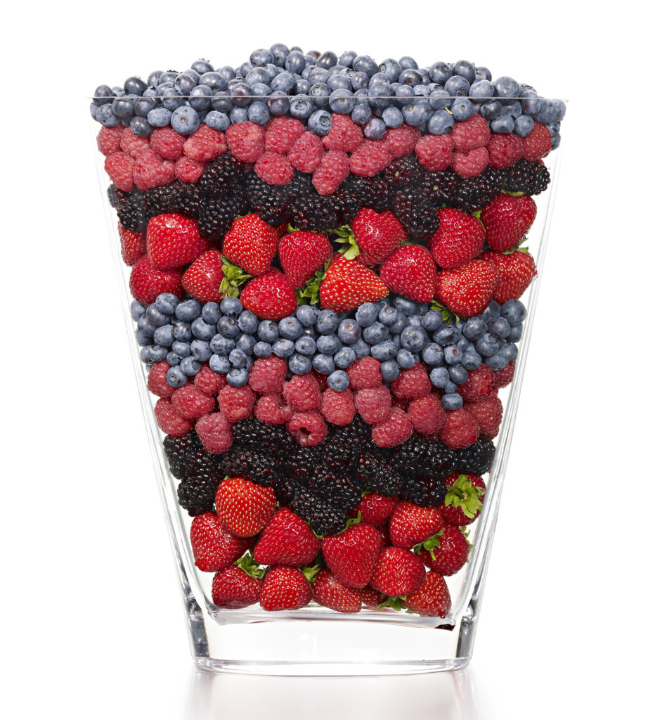 Berries lining a vase
