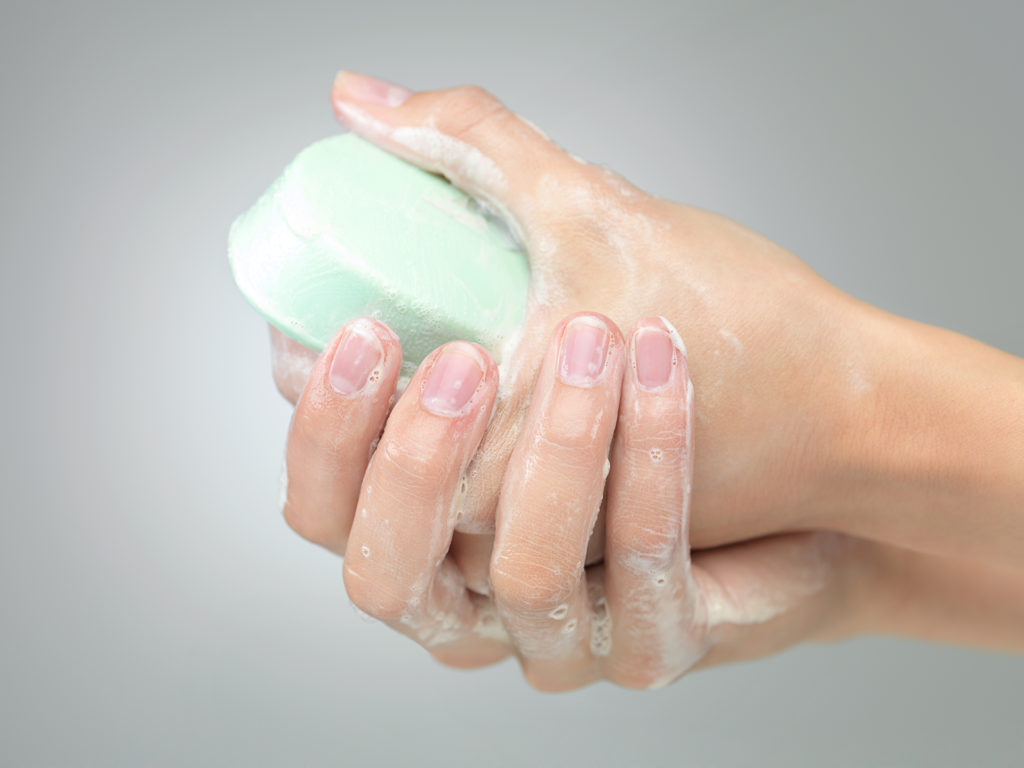 Woman washing her hands with soap
