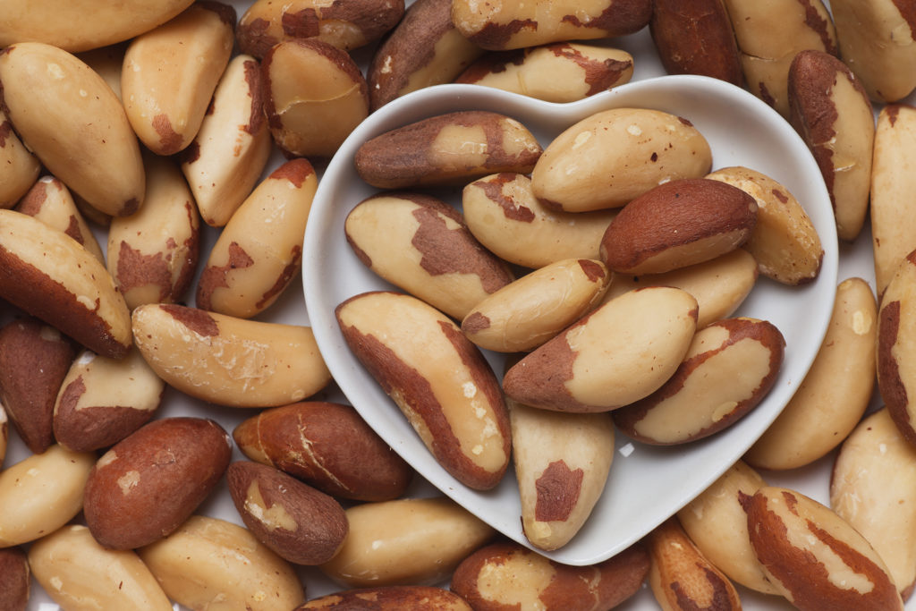 Brazil nut, healthy food ingredient in heart shaped tray; 