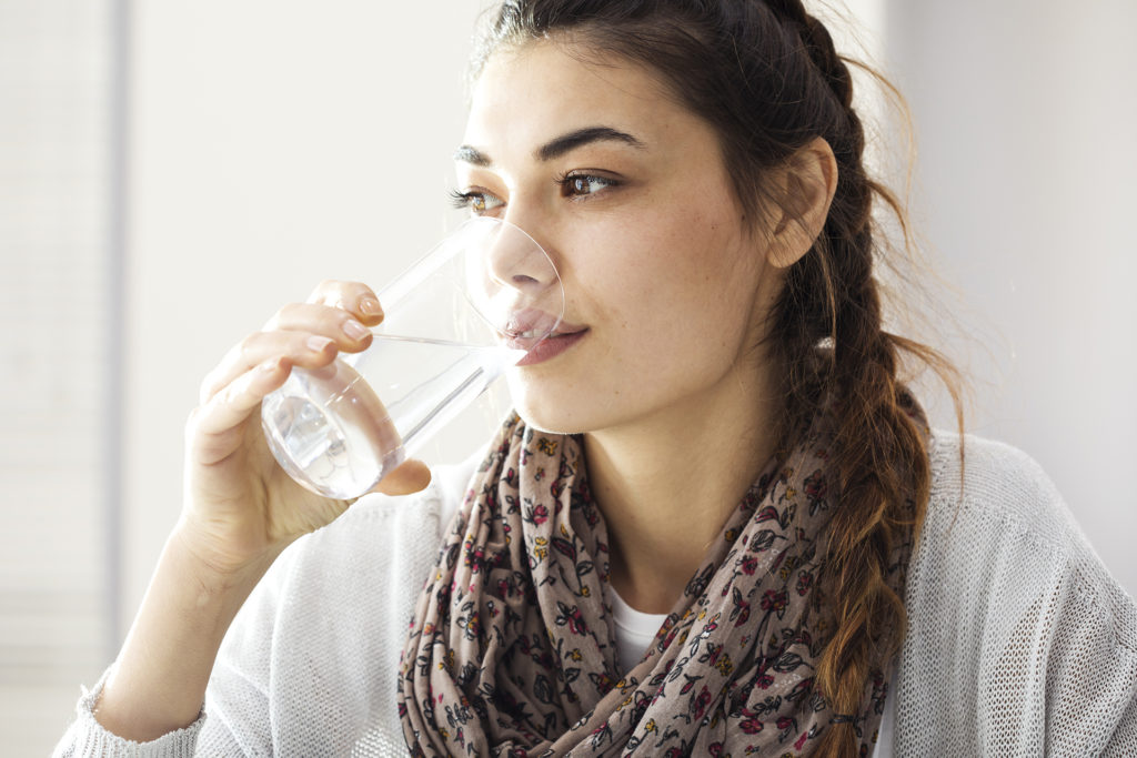 Young woman drinking water; 