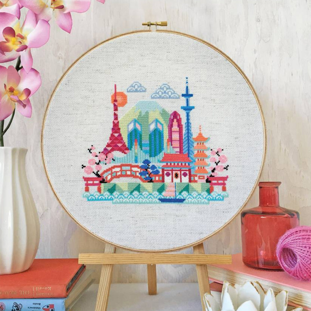circular cross stitch frame with fairytale landscape of towers and bridges