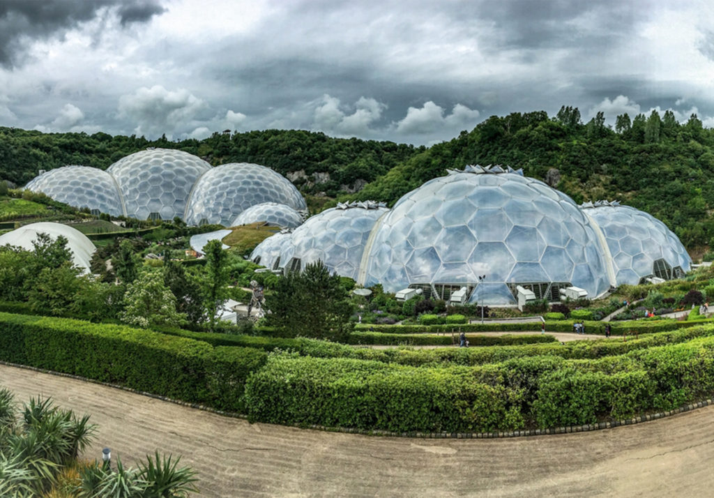 Series of glass domes in countryside, gardens in foreground