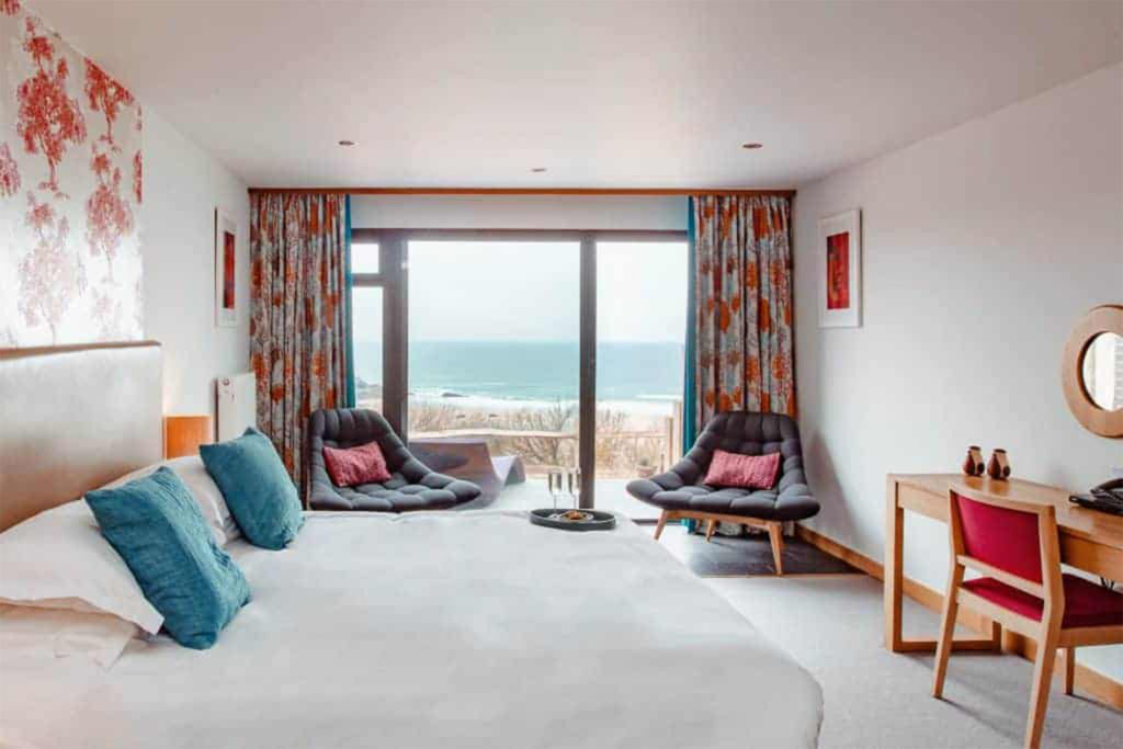 View through hotel room to sliding glass doors and view of the beach