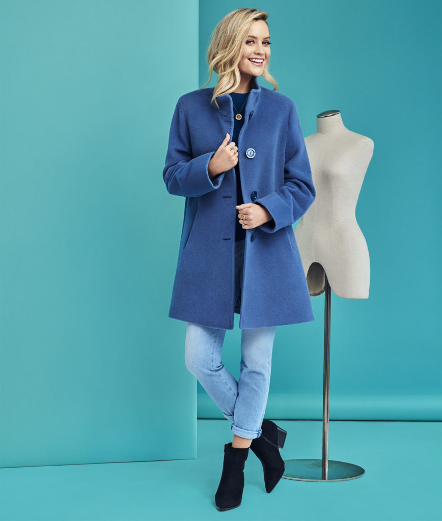 blonde woman in blue coat with lapels and blue jeans 