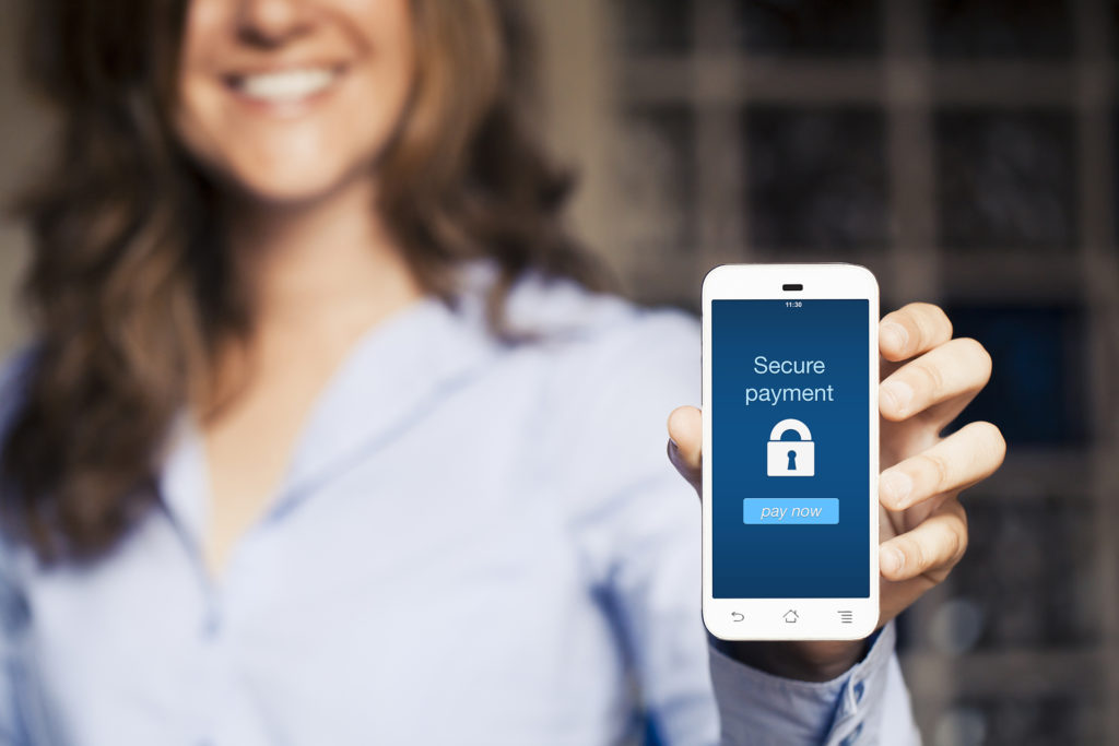 Secure payment message on a mobile. Smiling woman holding mobile phone screen