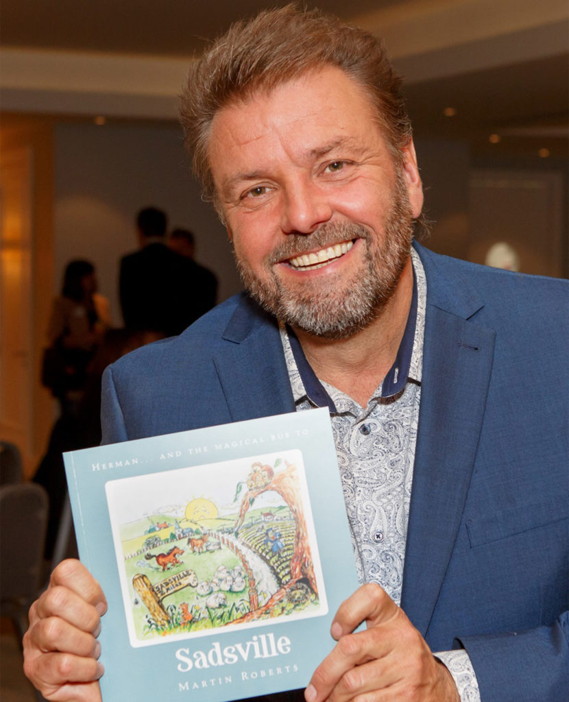 TV presenter and author Martin Roberts with his book Sadsville