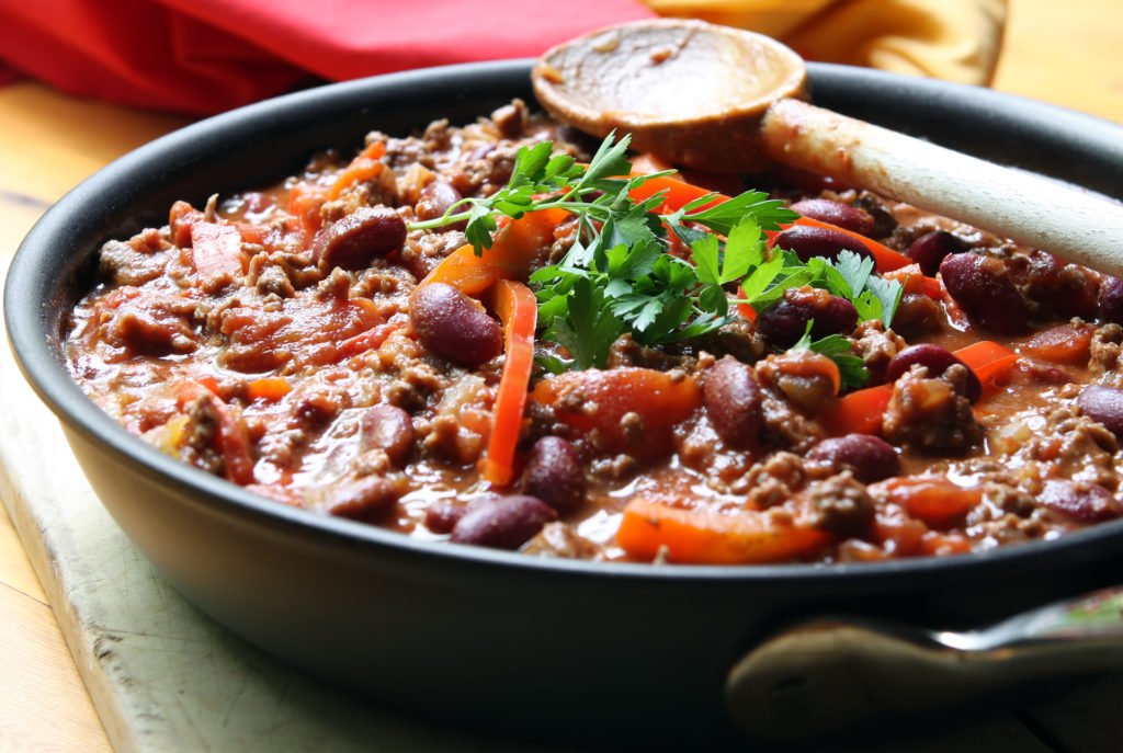 A pan of chilli, ready to serve.  Soft focus, shallow depth of field.; 