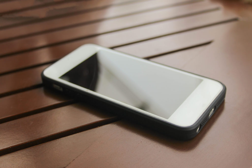 soft focus mobile phone on wooden floor; 