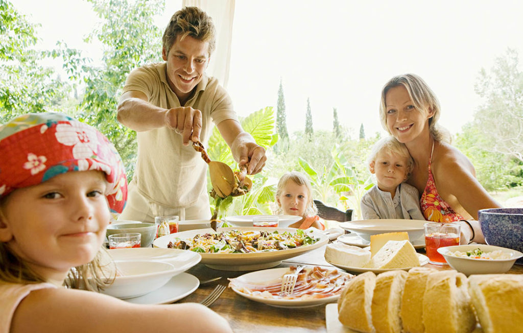A family eating al fresco at the villa Pic: Shutterstock