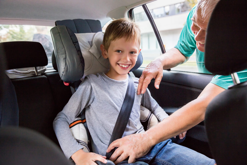 Man Checking Seat Belt Buckling For Child In Safety Seat In Car Before Driving; Shutterstock ID 514909840