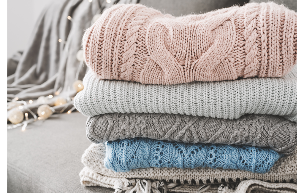 Pile of pastel coloured sweaters, folded neatly