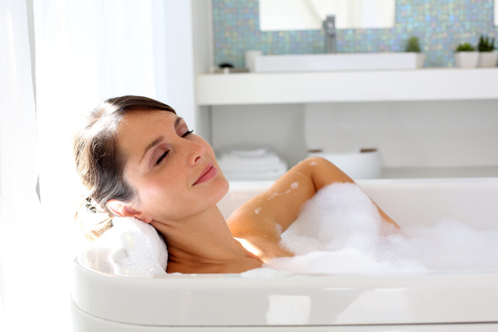 Beautiful woman relaxing in bathtub; 