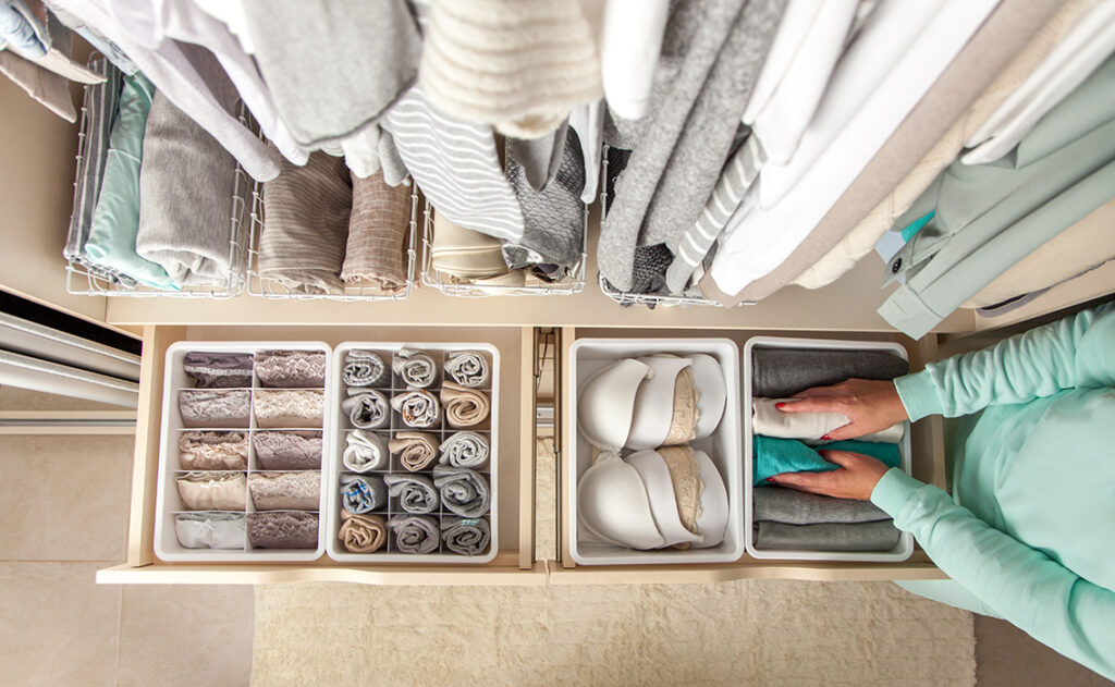 Lady tidying wardrobe Pic: Shutterstock